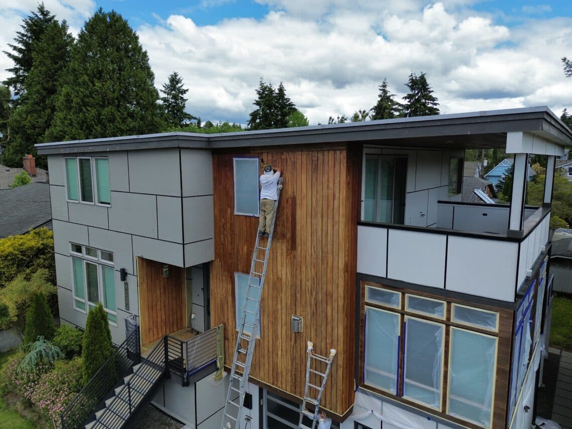 Painter sanding wood that will be stained in Seattle, Washington